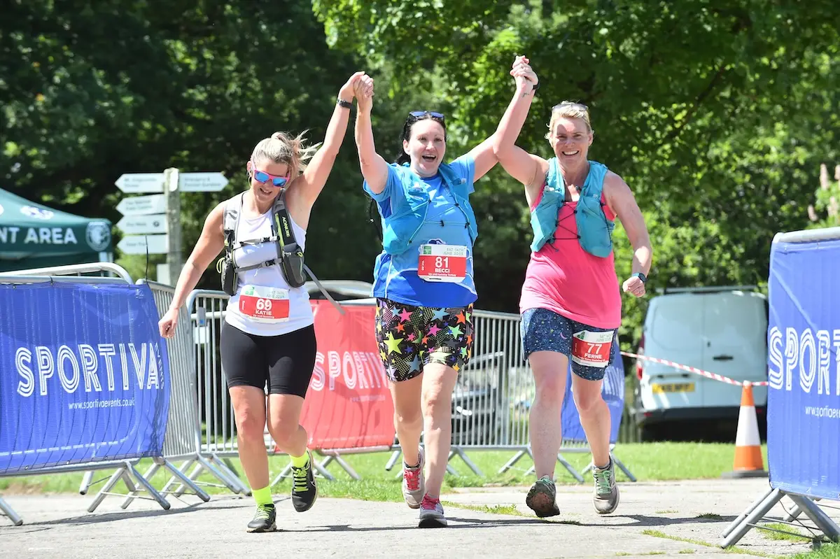Participants crossing the finish line at the English Riviera Festival